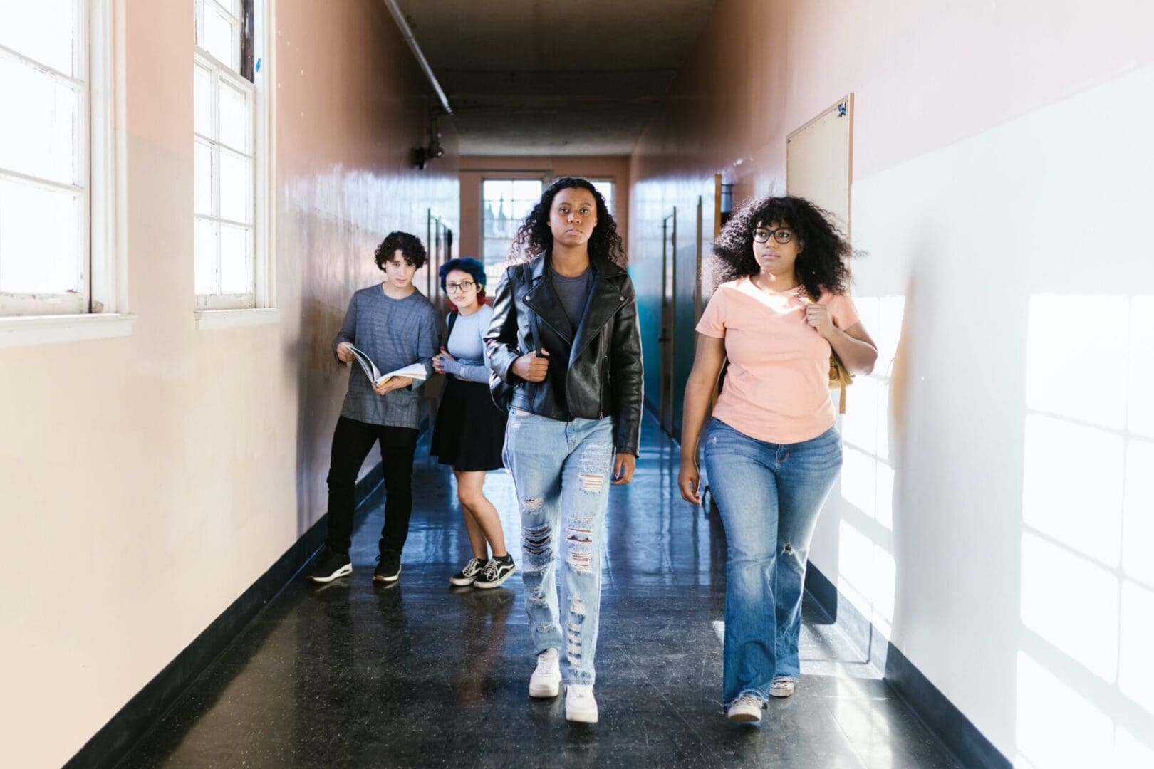 A group of people walking down the hall way
